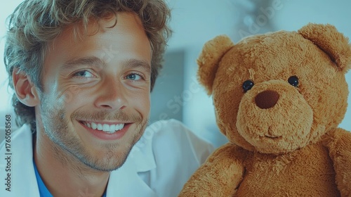 A friendly healthcare professional smiling with a teddy bear in a warm and inviting environment.