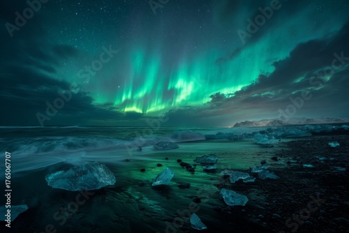 Bright green auroras dance across the night sky above a dark shoreline covered with scattered ice chunks. The waves softly crash, creating a magical scene