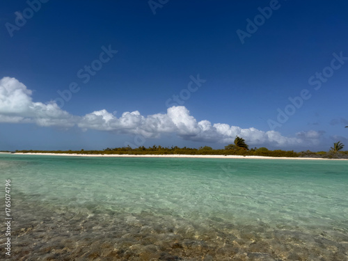 Фотография Crystal-clear turquoise waters lap onto a pristine white sand shoreline on Kiritimati (Christmas Island), Kiribati
