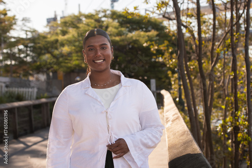 young indian woman walking on a boardwalk next to the Brisbane River