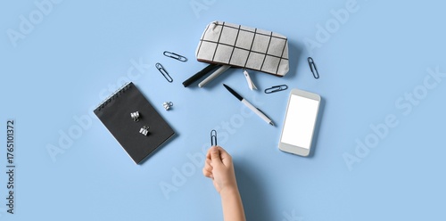 Hand with school stationery...