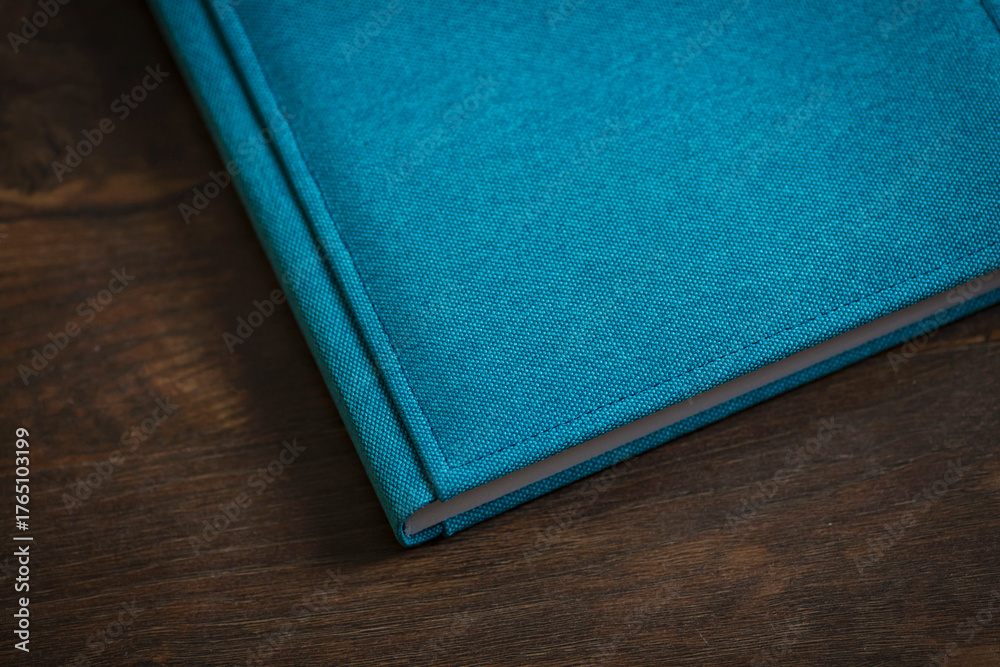 Fototapeta premium Captivating turquoise journal resting on a rustic wooden table invites creativity and inspiring thoughts at any time of the day