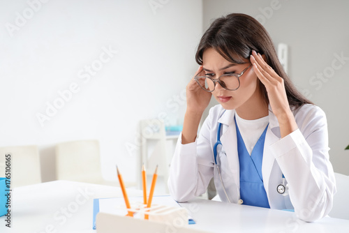 Thoughtful female doctor at...