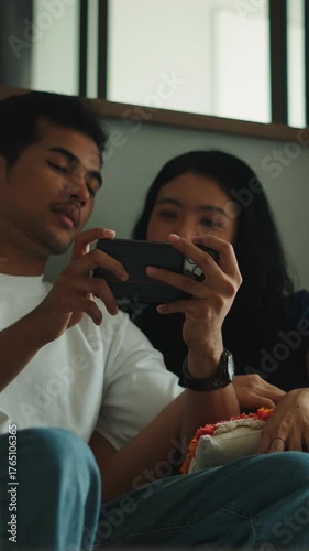 Young couple watching videos on smartphone