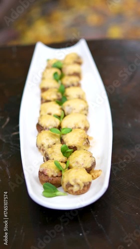 baked champignon mushrooms stuffed with herb cream cheese and topped with parmesan. High quality FullHD footage