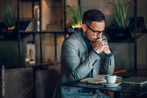 Businessman working remotely from cafe is thinking about his next move