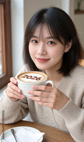 woman eating breakfast, I'm making a cappuccino and it says 2026 on the foam.
