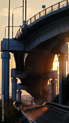 Modern bridge against the backdrop of sunset, architecture and light of the evening city.