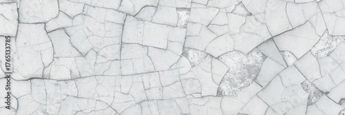 Peeling paint on the wall. Old concrete wall with cracked flaking paint. Weathered rough painted surface with patterns of cracks and peeling. High resolution texture for background and design. Closeup