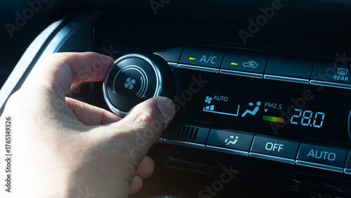 Tableau sur toile Man hand adjusting the temperature of a car climate control panel
