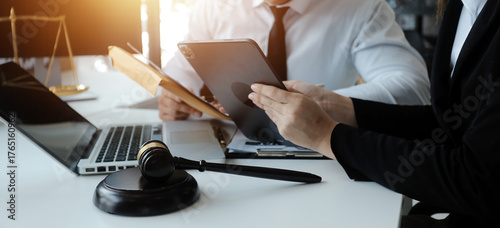 Male lawyer working with contract papers and wooden gavel on tabel in courtroom. justice and law ,attorney, court judge, concept.