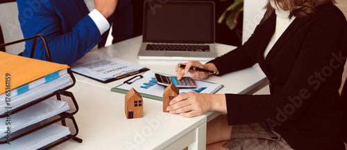 Female woman hands holding home model, small miniature white toy house. Mortgage property insurance dream moving home and real estate concept
