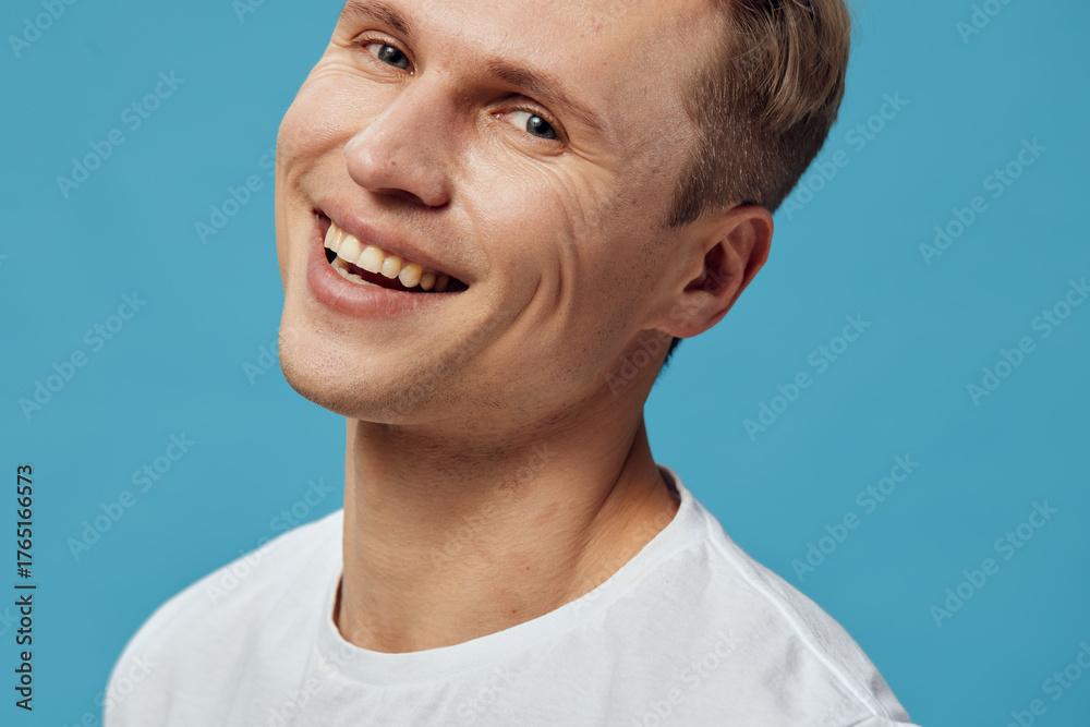 Obraz premium Smiling happy young caucasian man wear white shirt isolated on blue background studio portrait digital detox concept