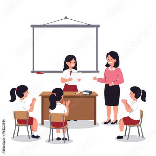 a student giving a presentation at the front of the class while the teacher stands nearby smiling. 