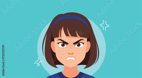 Young girl displays an angry expression with furrowed brow and gritted teeth.