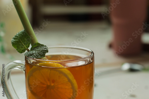 glass of hot lemon tea with mint and lemon grass