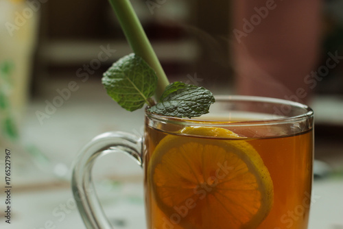 glass of hot lemon tea with mint and lemon grass