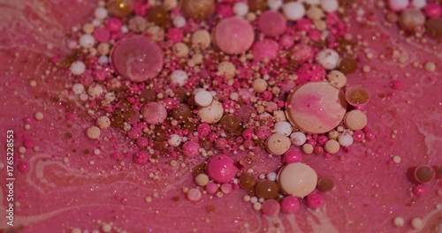Color bubbles. Oil fluid. Defocused pink orange white ink glitter acrylic water shiny round texture floating on abstract art background.