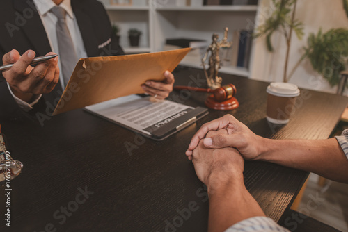 A professional lawyer discussing legal matters with a client in an office, providing legal advice and document review services, symbolizing justice, trust, and professional consultation.