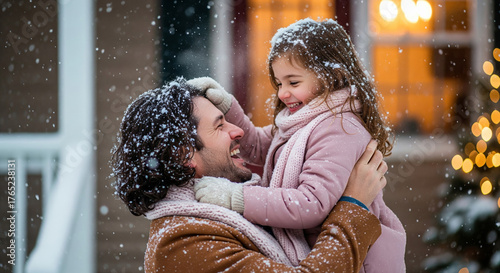 Smiling father and daughter enjoying a snowy winter day with holiday lights