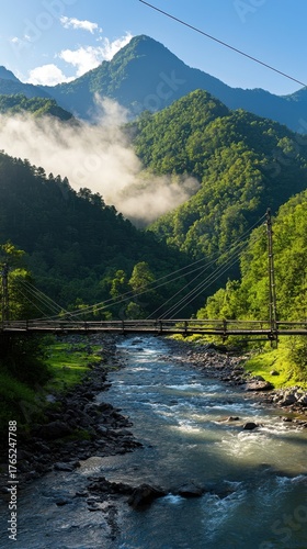 Scenic Mountain View with River and Suspension Bridge at Sunrise
