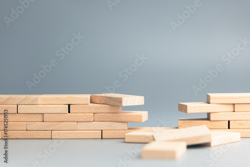 Fotografi Wooden blocks forming a wall or bridge with a missing section symbolizing gap an