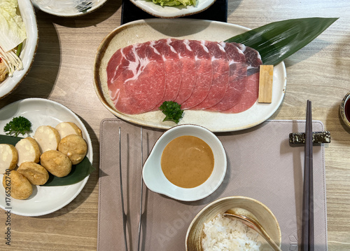 Top View of Set of Shabu including Sliced Beef, Rice, Sauce, Tofu and Vegetable