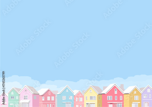 Una fila di case colorate con soffici nuvole bianche su uno sfondo blu