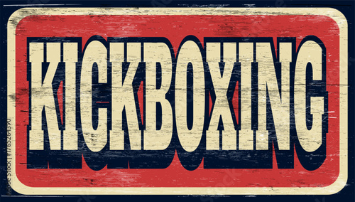 Aged and worn kickboxing sign on wood