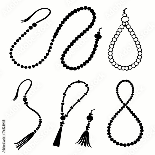 Black prayer beads and tassels on white background