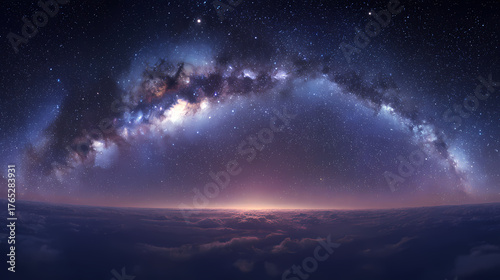 A breathtaking view of the Milky Way galaxy arching across the night sky, with a hint of sunrise over the horizon