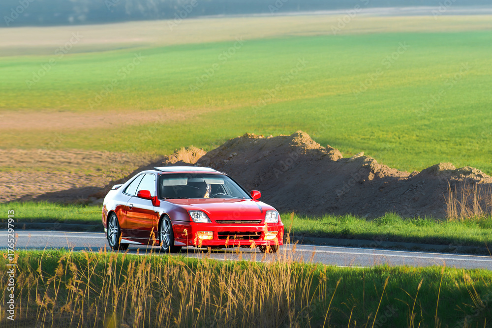Fototapeta premium Customized red coupe representing modern car tuning