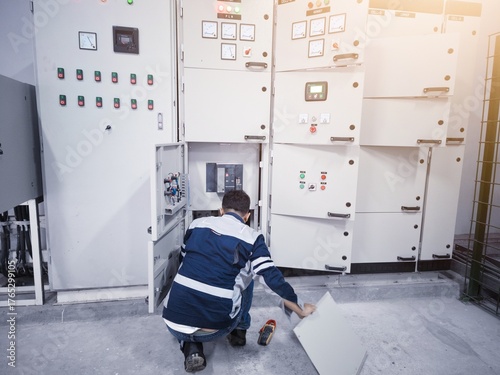 The technician check and comissioning panel control on the power house in industry.