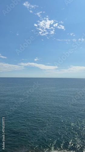 Calm blue sea and blue sky, vertical video.