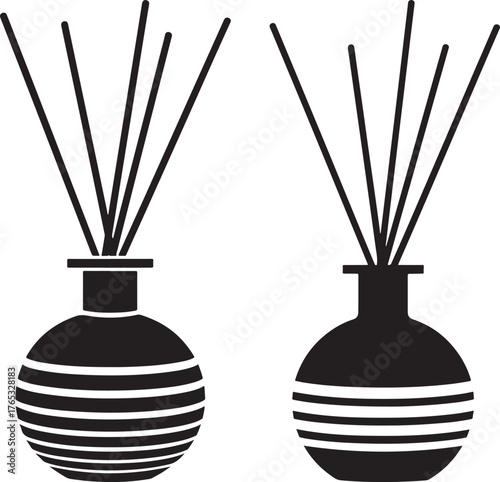 Two round glass diffuser bottles with reeds silhouette