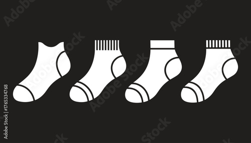 Four white socks with different patterns on black background clothing apparel