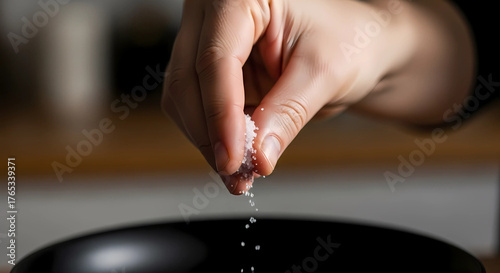 Pinch of salt in woman's hand