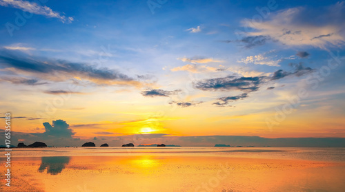 A breathtaking sunset or sunrise illuminates the ocean horizon and serene seascape