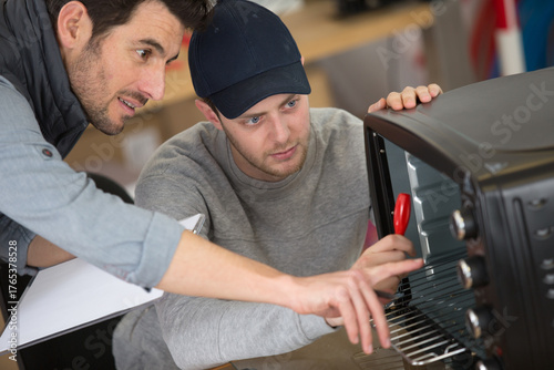 Photography electrician working on tabletop oven