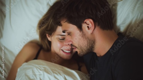 A couple of lovers in bed. Tension. I love you. Intimacy. A boyfriend whispering some nice words to his girlfriend and she is in mood
