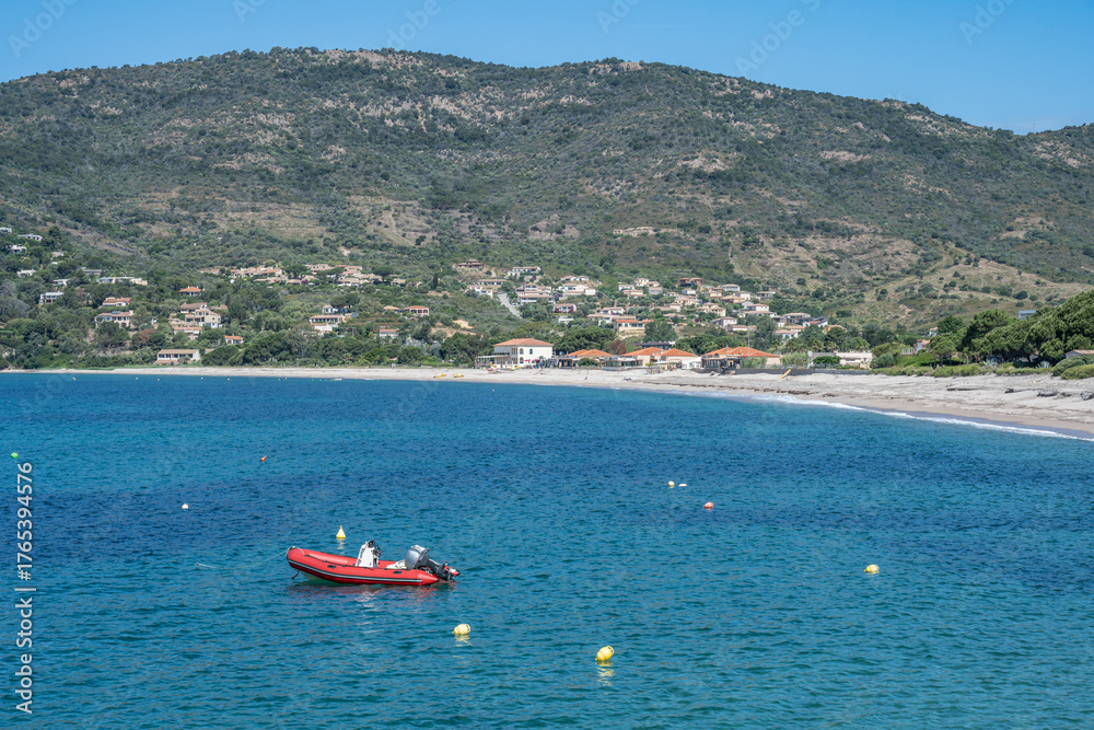 Obraz premium Spectacular view Golf at Sagone Corsica France beautyful sand Beach boats mountain village Tourism and vacations concept