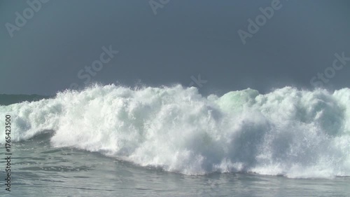 Bodyboarder riding giant swell waves at The Wedge