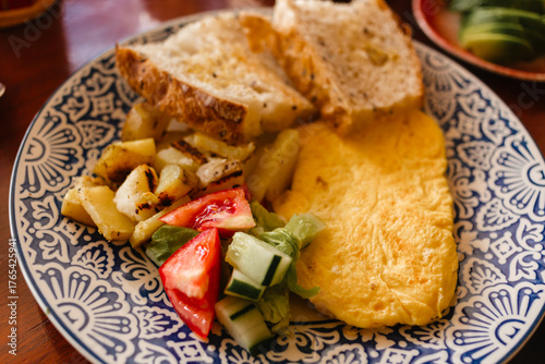 Omelet with vegetable salad for breakfast. Delicious meal in the morning