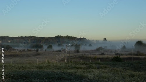 View from Pulkovo Heights as an airplane takes off over hill covered in trees in early frosty morning, Southern outskirts of St. Petersburg, Russia