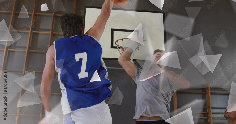 Fototapeta premium Leaping player in blue #7 jersey grabbing orange basketball at gymnasium hoop with climbing racks