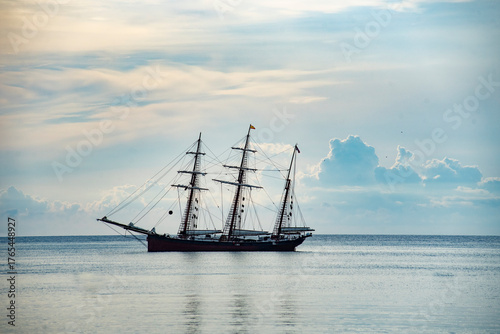 old sailboat at the mouth of the harbor