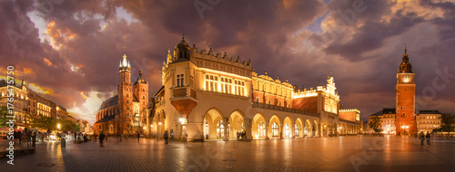 Panorama of St Mary's Basilica (Mariacki Church) and The Main Market  and tower in the Old Town of Krakow, Poland illuminated at night after sunset