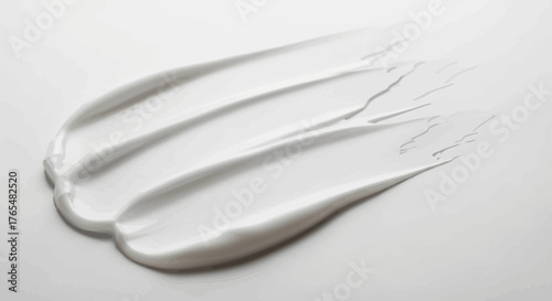 Glossy white cosmetic cream swatch smeared in a thick, textured stroke with smooth ridges.