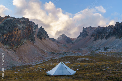 Tent sits alone in a vast mountain landscape