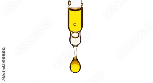 Golden yellow viscous liquid drop forming from clear glass pipette, showcasing its glossy texture and amber hue.